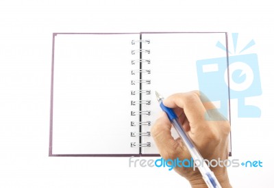 Hand Holding Blue Pen Writing On Notebook Stock Photo
