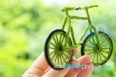 Hand Holding Eco Bicycle Stock Photo