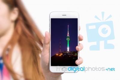 Hand Holding Smart Phone With Photo Of Seoul Tower Isolated On White Background Stock Photo