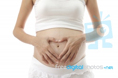 Hand On Abdomen Of Pregnant Woman On White Background Stock Photo