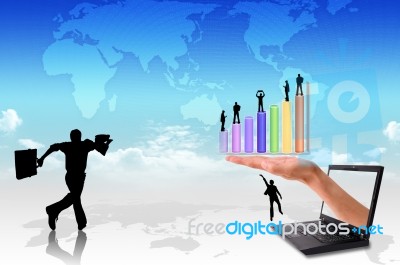 Hand  Out Of An Laptop With Silhouette People And Graph  Stock Photo