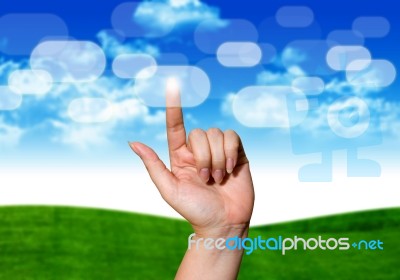 Hand Pushing Button On Blue Sky Stock Photo