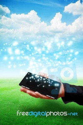 Hand With Smart Phone With Sparkle Stock Photo
