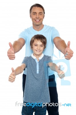 Handsome Father And Son Showing Thumbs Up To Camera Stock Photo