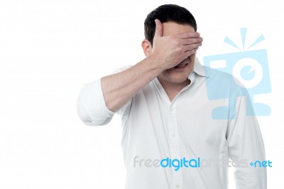 Handsome Man Covering His Eyes With Hand Stock Photo