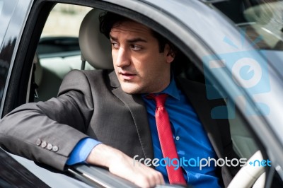 Handsome Man Driving His New Car Safely Stock Photo