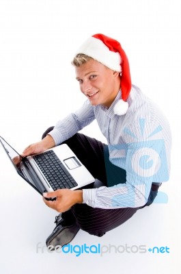 Handsome Man With Christmas Hat And Laptop Stock Photo