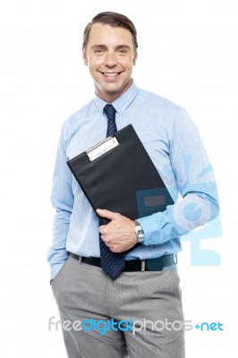 Handsome Smiling Executive Holding Clipboard Stock Photo