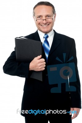 Happy Businessman Holding Files Stock Photo