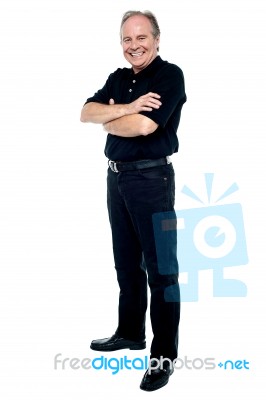 Happy Man In Black Attire Posing With Arms Folded Stock Photo