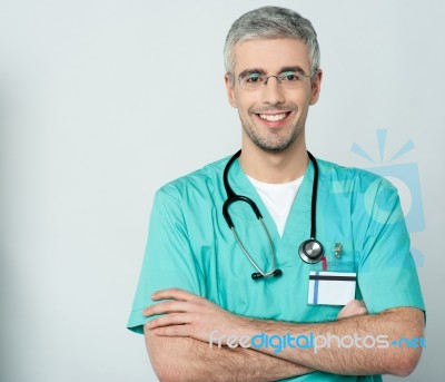 Happy Medical Doctor With Arms Crossed Stock Photo