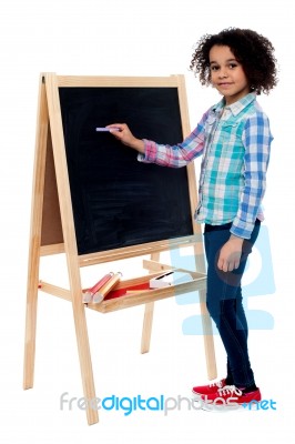 Happy Schoolchild Writing On Blackboard Stock Photo