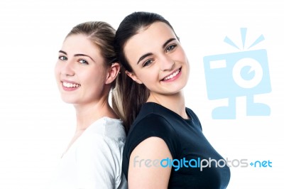 Happy Teen Girls Standing Back To Back Stock Photo