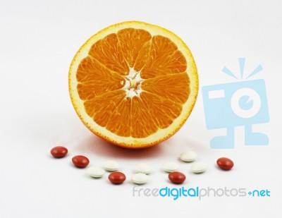 Healthy Orange With Vitamin And Mineral Tablets Stock Photo