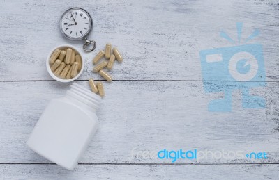 Herbal Capsule With Vintage Watch And Whit Plastic Bottle Stock Photo
