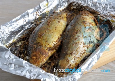 Herring In Spices And Herbs In Foil Stock Photo