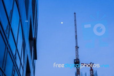 High Business Building With Metal Crane At Dawn Stock Photo