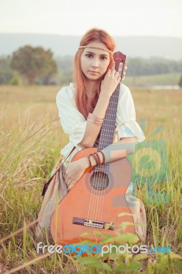 Hippie Girl Playing Guitar On Grass Stock Photo