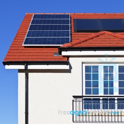 House Roof Covered With Solar Panels Stock Photo