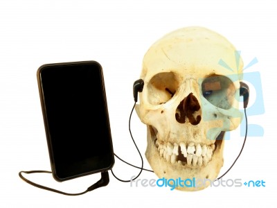 Human Skull Listening Music On Mobile Device Stock Photo
