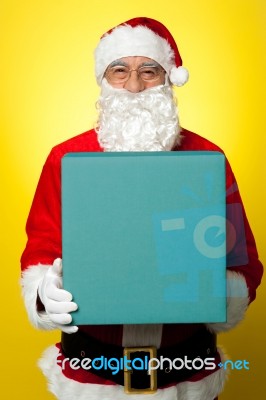 Isolated Smiling Santa Holding Gift Box Stock Photo