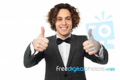 Joyous Young Guy Gesturing Double Thumbs Up Stock Photo