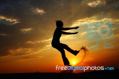 Jumping And Sunset Stock Photo