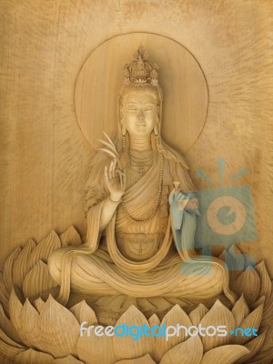 Kuan Yin Image Of Buddha , Wood Carving In A Thai Temple Stock Photo