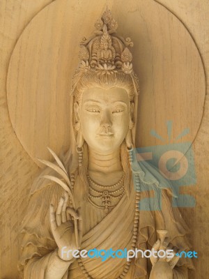 Kuan Yin Image Of Buddha , Wood Carving In A Thai Temple Stock Photo