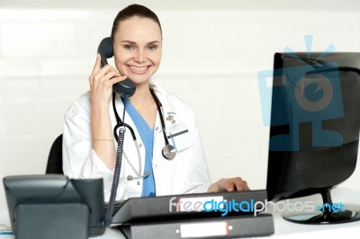 Lady Doctor Talking Over Phone Stock Photo