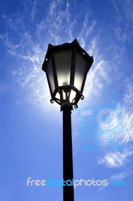 Lamppost In Backlight On Sky Stock Photo