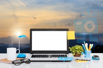 Laptop Computer On Desk And Landscape View Background Stock Photo