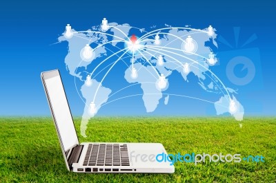 Laptop On Grass And Social Network Structure Stock Photo