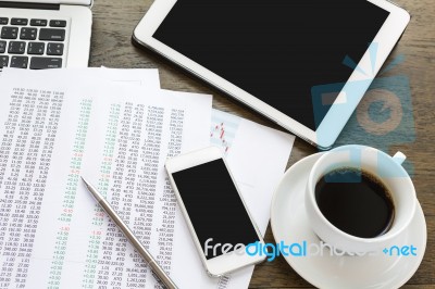 Laptop, Tablet , Smartphone And Coffee Cup With Financial Docume… Stock Photo