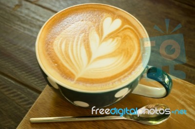 Latte Art Coffee Cup On Wood Table Stock Photo