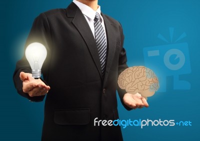 Light Bulb And Brain In The Hands Of Businessmen Stock Image