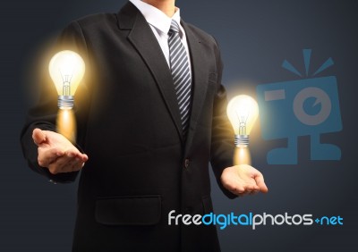 Light Bulb In Hand Stock Image