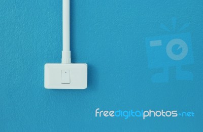 Light Switch On Blue Wall Stock Photo