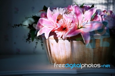 Lily Flower In Wood Bucket With Cookie Light In Home Living Room… Stock Photo