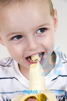 Little Boy Eating Banana Stock Photo