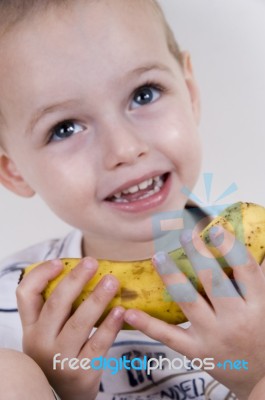 Little Boy Holding Banana Stock Photo