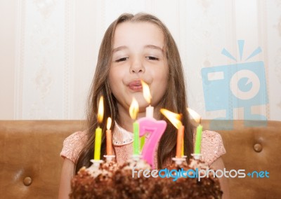 Little Girl Blowing Out The Candles Stock Photo