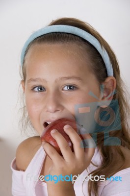 Little Girl Eating Apple Stock Photo