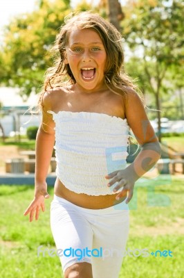 Little Girl Running In Outdoor Stock Photo