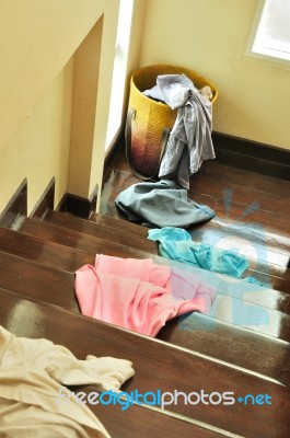 Lots Of Messy Clothes On A Cloth Basket And Stair Stock Photo