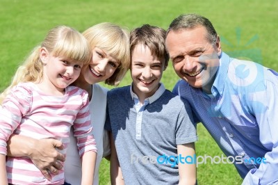 Lovable Family Enjoying Sunny Day Outdoors Stock Photo
