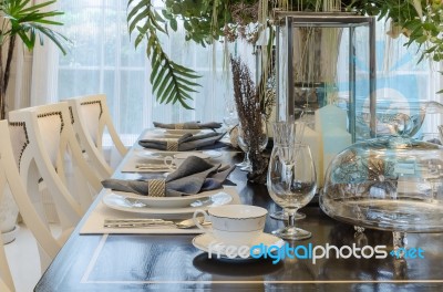 Luxury Dinning Room With Table Set On Wooden Table Stock Photo