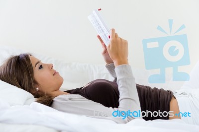 Lying Beautiful Woman Reading Book At Home Stock Photo