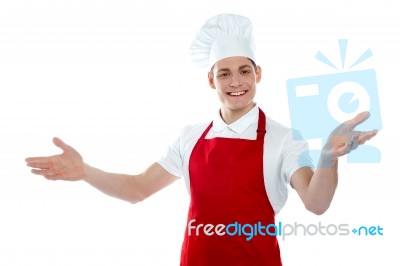 Male Chef Giving Welcome Gesture Stock Photo