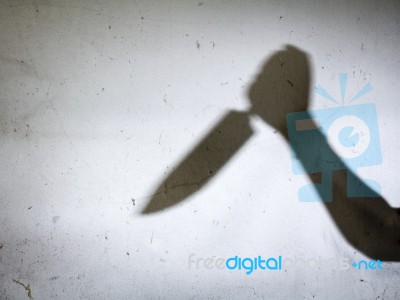 Male Hand Shadow With Knife Stock Photo